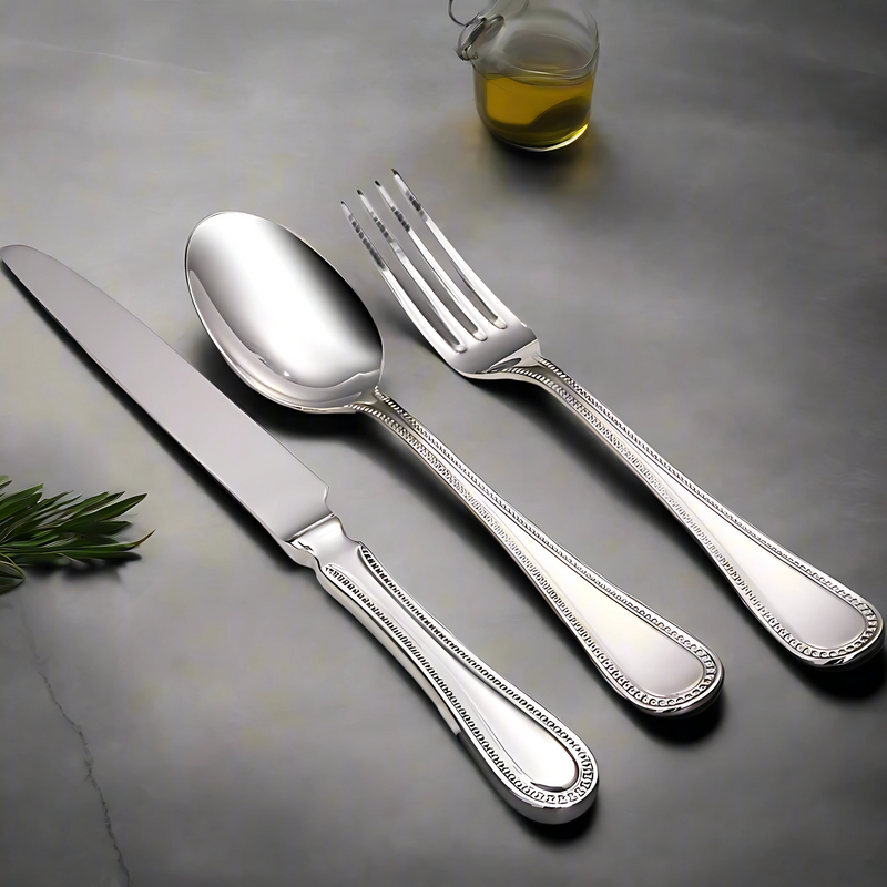 Pearls 2003 cutlery set displayed in full table setting

Close-up of beaded edge design on Pearls 2003 knife

Table fork and dessert spoon from Pearls 2003 collection

Cake fork and tea spoon – Pearls 2003 stainless steel

Coffee spoon and soup spoon – Pearls 2003 pattern

Elegant steak knife with pearl detail – Pearls 2003

Complete Pearls 2003 flatware set in polished finish

Pearls 2003 dessert knife and fork laid on napkin