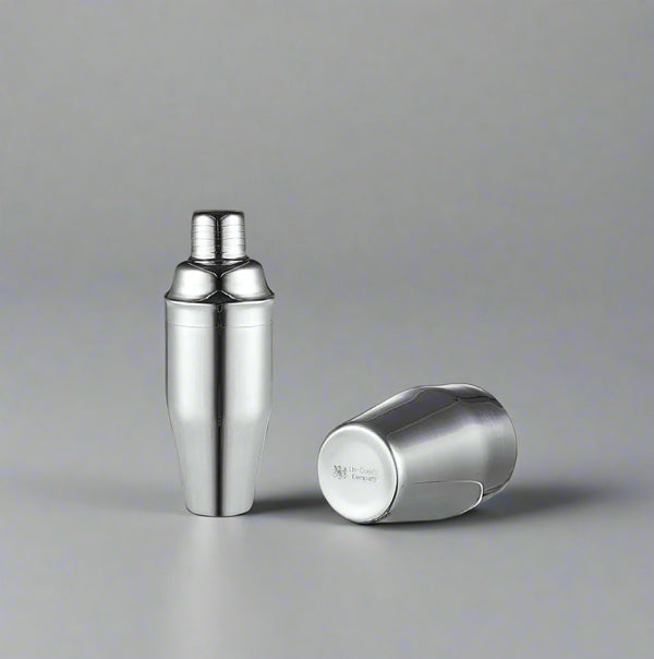 The Cooks Company 700 ml Stainless Steel Cocktail Shaker blends flavors smoothly and chills drinks fast. Ideal for mojitos, margaritas, and more.Stainless Steel Cocktail Shaker – 700 ml

700 ml cocktail shaker with sleek finish by The Cooks Company

Mixing mojito with stainless steel shaker – The Cooks Company

Side view of 700 ml bartender cocktail shaker

Shaker on bar top filled with ice – The Cooks Company

Polished stainless steel drink shaker for home and bar use

The Cooks Company cocktail shaker set